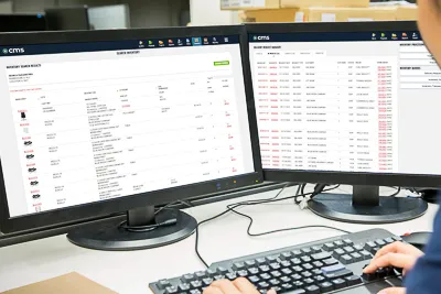 a person looking at two computer screens displaying CMS inventory Moving company inventory software data